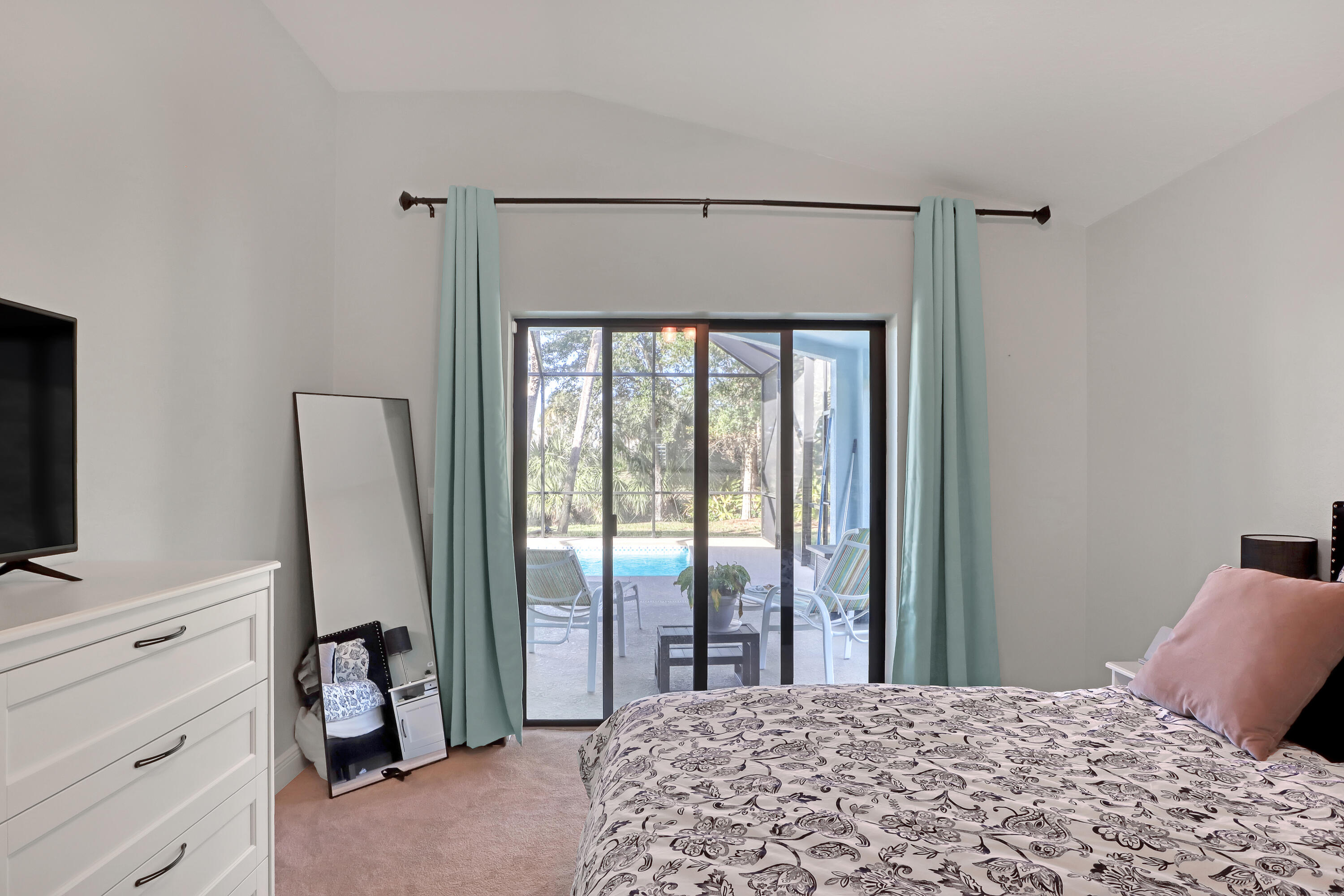 1358 Outrigger Circle Rockledge, FL 32955 - Photo 24 of 48 a bedroom with a bed and a flat tv screen on dresser