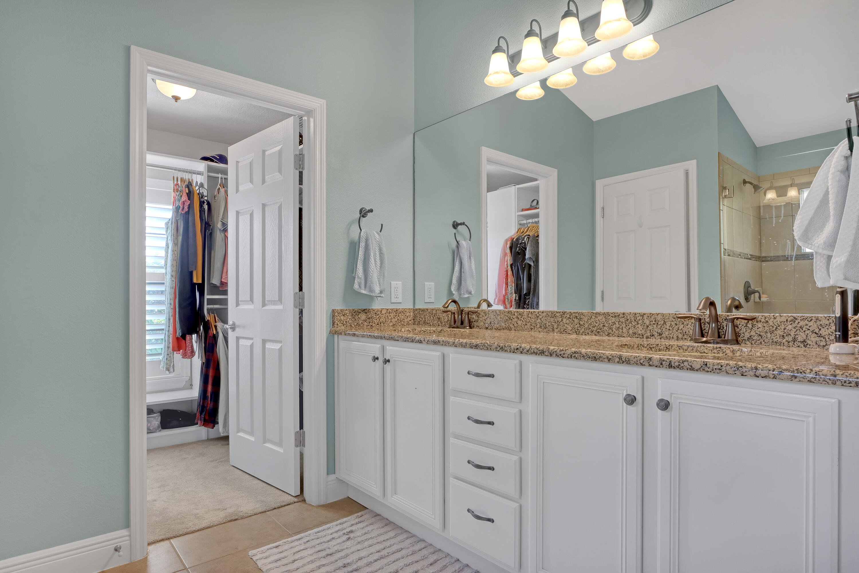 1358 Outrigger Circle Rockledge, FL 32955 - Photo 27 of 48 a bathroom with a granite countertop double vanity sink mirror and