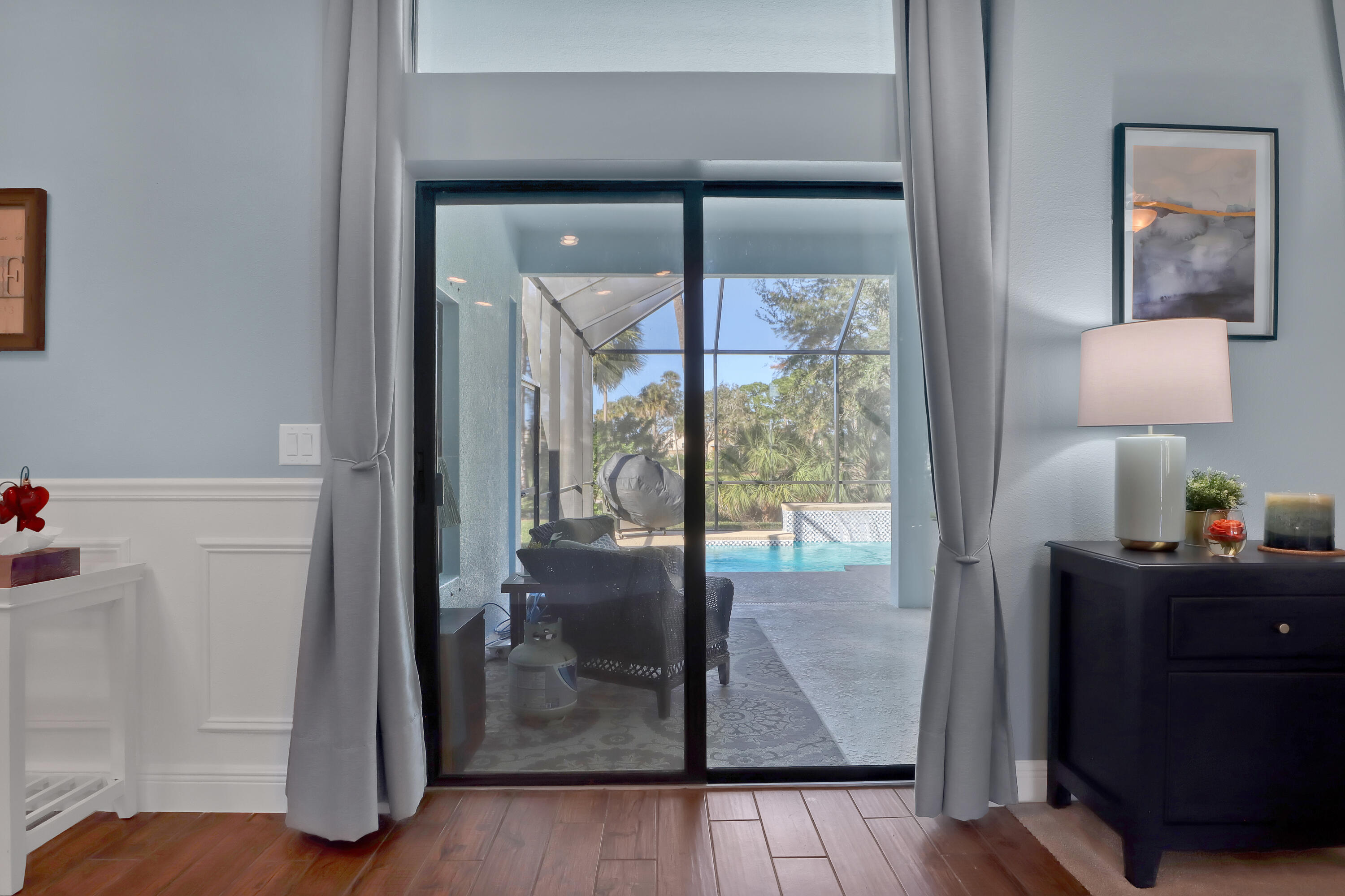 1358 Outrigger Circle Rockledge, FL 32955 - Photo 10 of 48 a view of a hallway with wooden floor and glass door