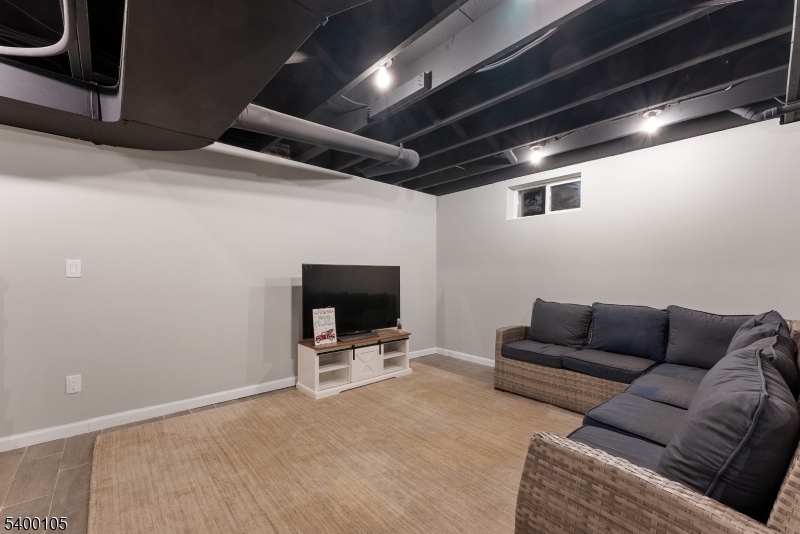 11 Furnace Road Chester, NJ 07930 - Photo 29 of 39 a living room with furniture and a flat screen tv