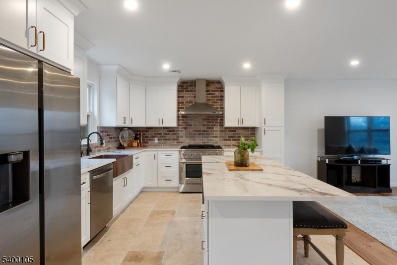 11 Furnace Road Chester, NJ 07930 - Photo 6 of 39 a kitchen with stainless steel appliances granite countertop a stove top oven a sink dishwasher a refrigerator and a dining table with wooden floor