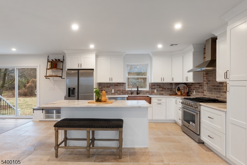 11 Furnace Road Chester, NJ 07930 - Photo 7 of 39 a kitchen with a refrigerator a stove cabinets and a dining table with wooden floor
