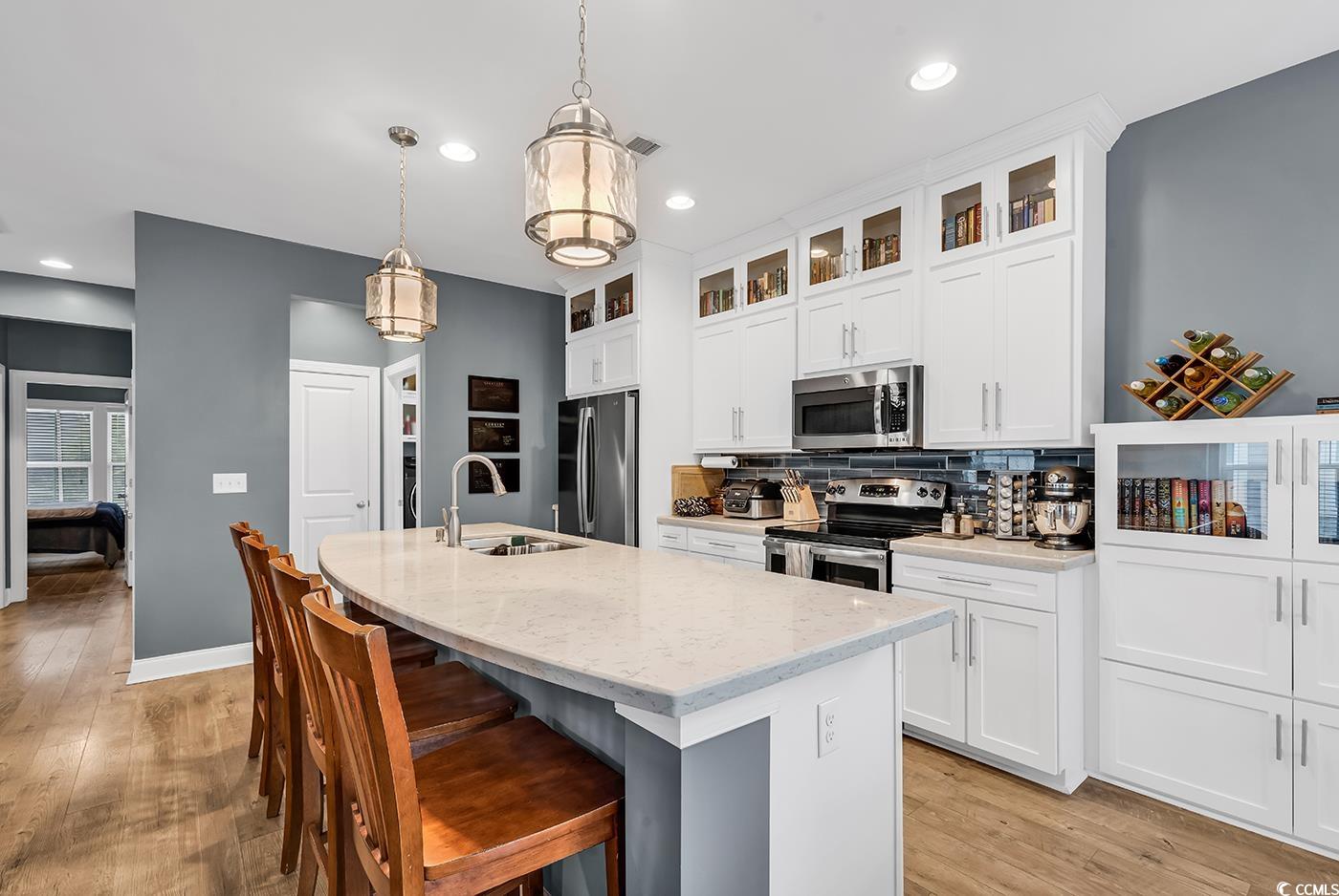 28 Pinnacle Drive Murrells Inlet, SC 29576 - Photo 11 of 40 Kitchen featuring a center island with sink, sink,