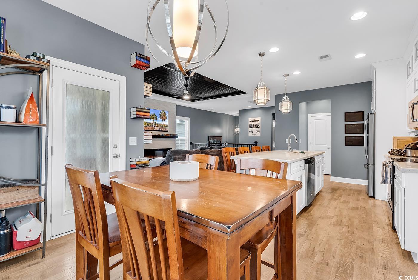 28 Pinnacle Drive Murrells Inlet, SC 29576 - Photo 15 of 40 Dining space with a fireplace, light hardwood / wo