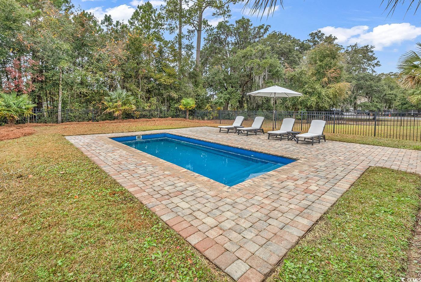 28 Pinnacle Drive Murrells Inlet, SC 29576 - Photo 28 of 40 View of swimming pool featuring a yard and a patio