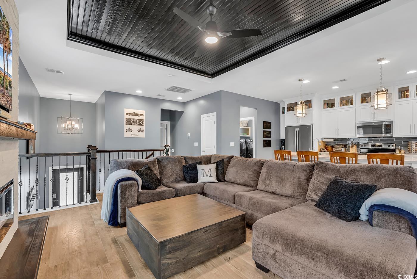 28 Pinnacle Drive Murrells Inlet, SC 29576 - Photo 8 of 40 Living room with ceiling fan with notable chandeli