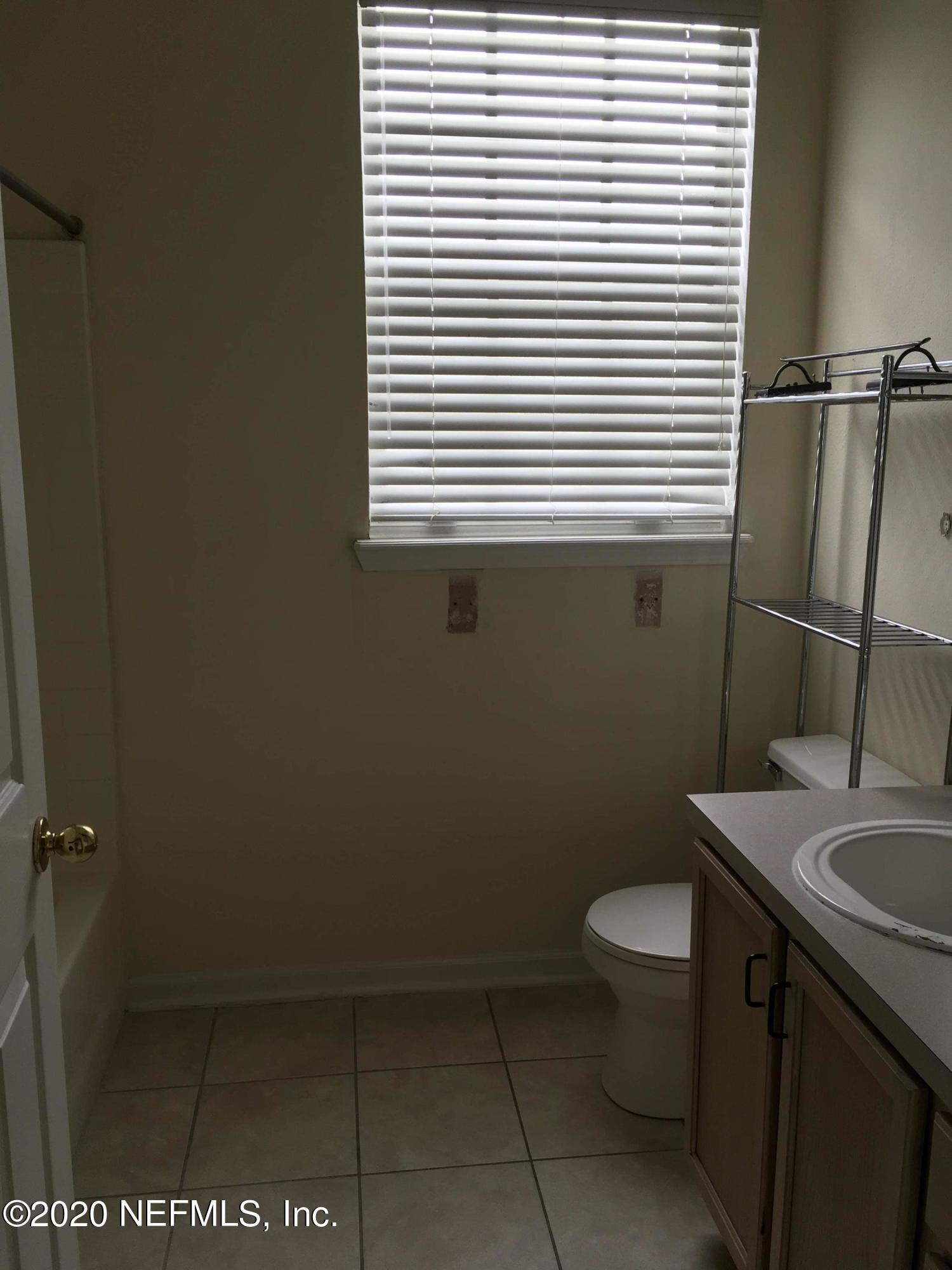 10550 Baymeadows Road, Unit 806 Jacksonville, FL 32256 - Photo 19 of 30 a bathroom with a sink a toilet and a window