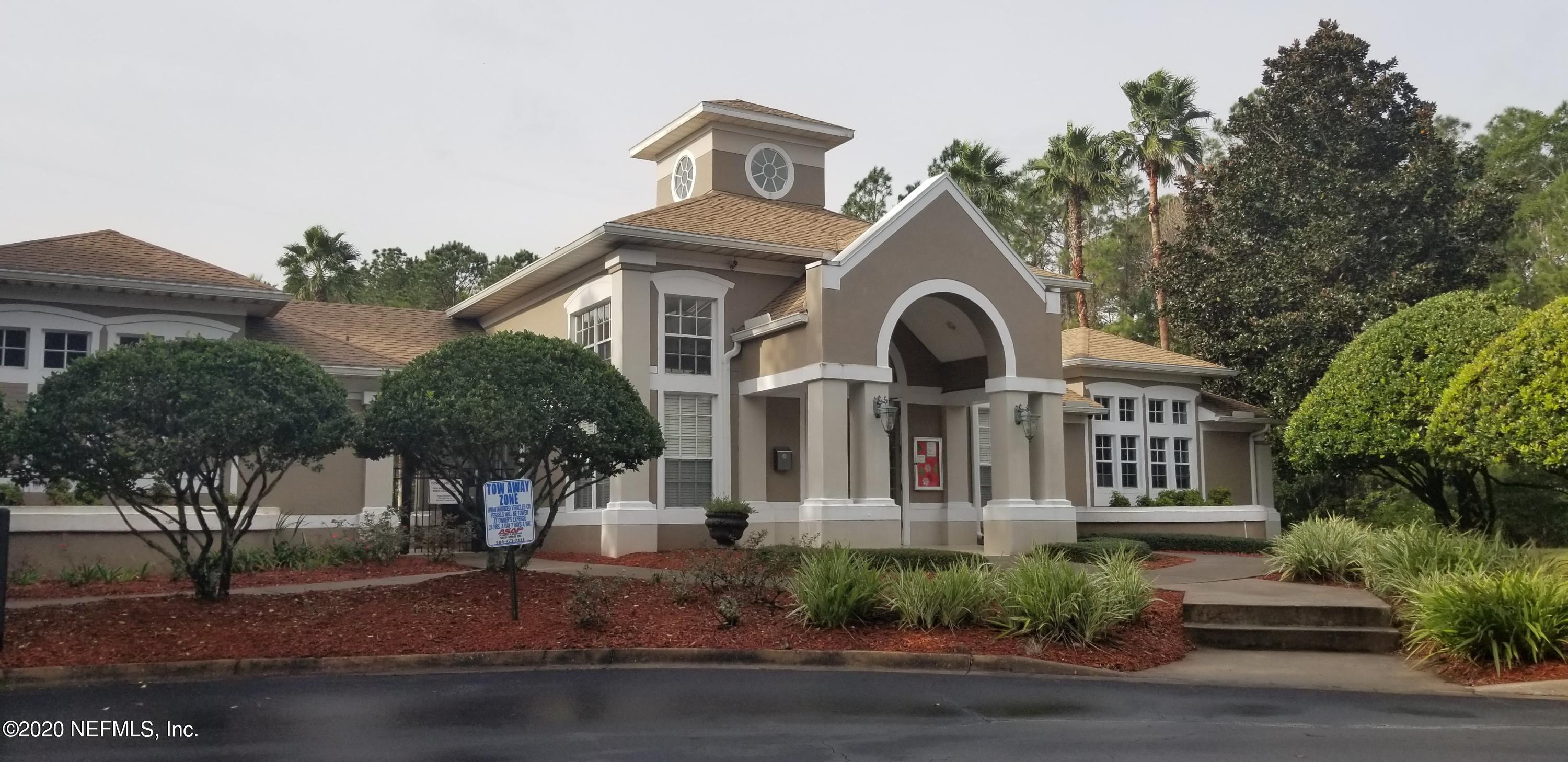 10550 Baymeadows Road, Unit 806 Jacksonville, FL 32256 - Photo 27 of 30 a front view of a house with a yard and garage