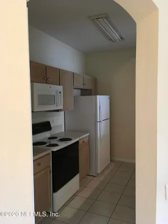 a kitchen with a refrigerator and a stove