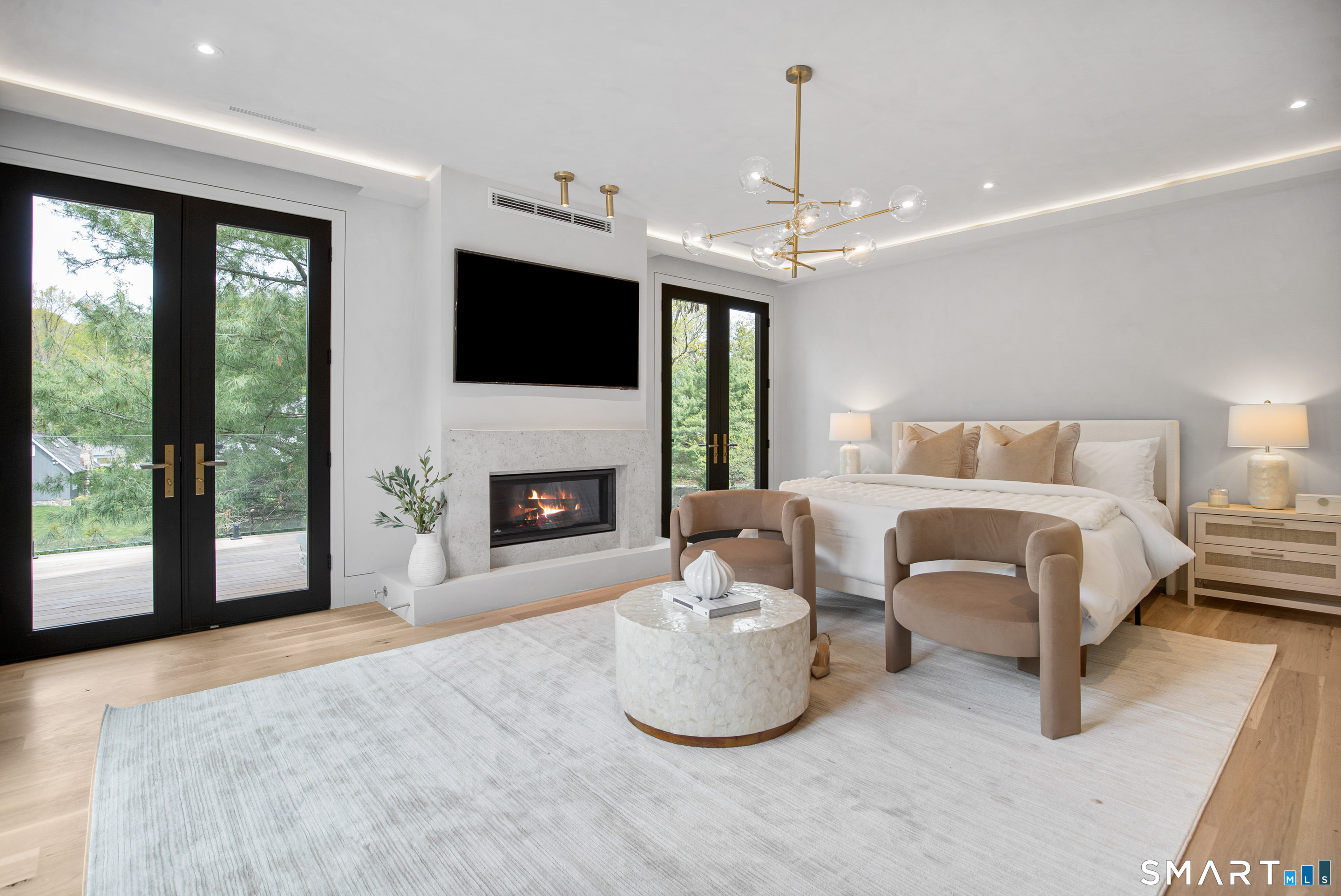 259 Frogtown Road New Canaan, CT 06840 - Photo 28 of 39 a spacious bedroom with a bed and a fireplace