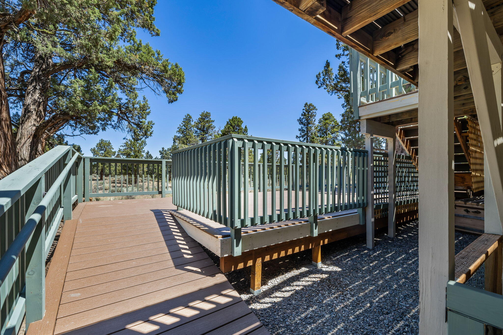 64586 McGrath Road Bend, OR 97701 - Photo 27 of 27 a view of a wooden deck with a bench