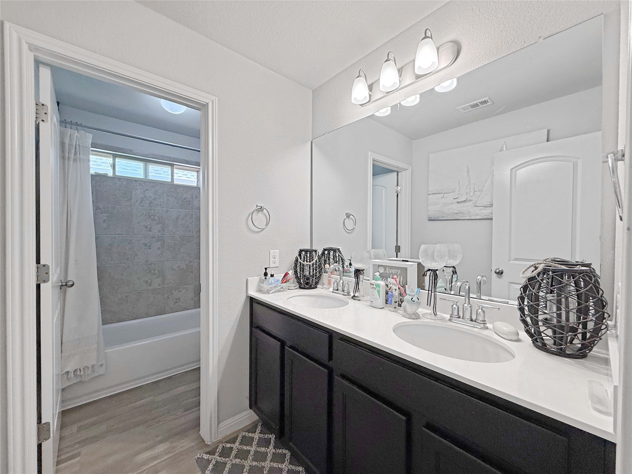429 Rusk Bluff Avenue Leander, TX 78641 - Photo 17 of 24 Double vanity sinks and bright overhead lighting define this modern bathroom space.