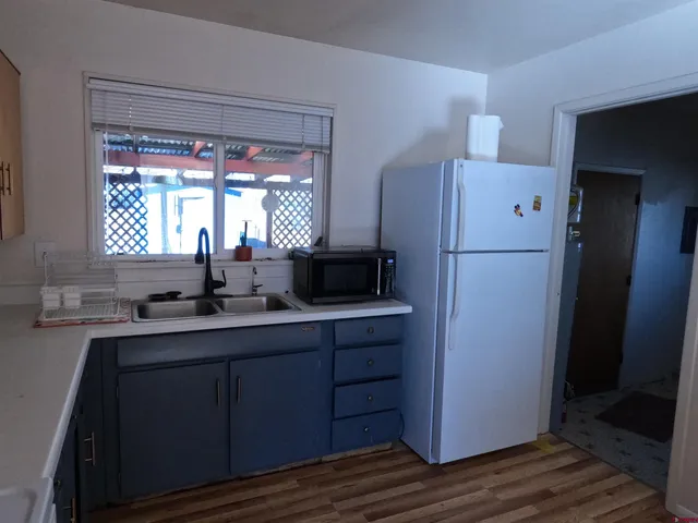 a kitchen with a refrigerator and a sink