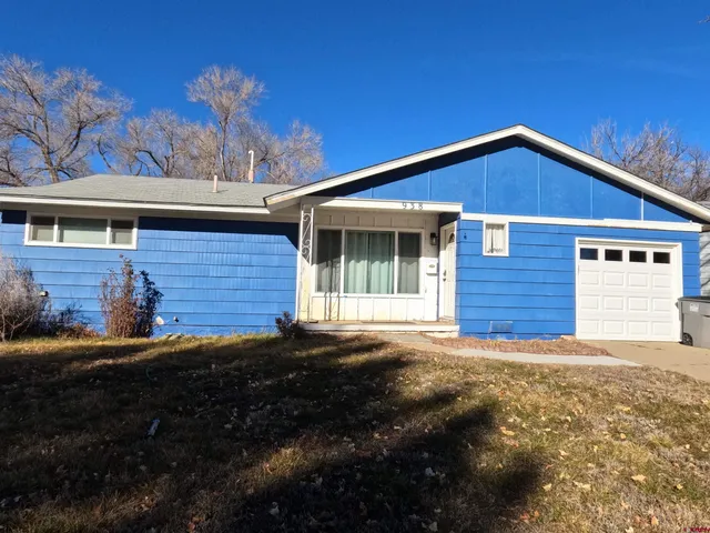 a view of house with backyard and garden