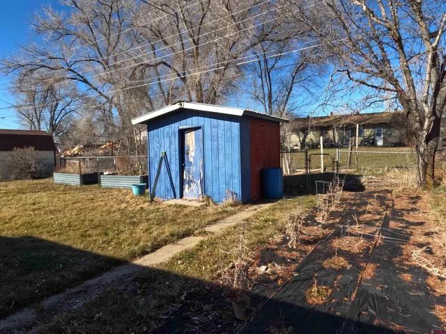 a front view of a house with a yard covered in snow