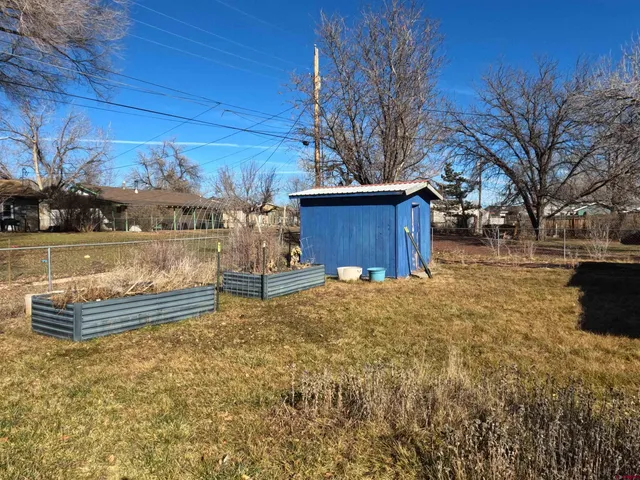 a view of a backyard with wooden fence