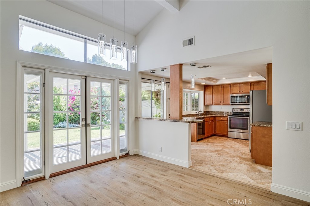 49 East Yale Loop, Unit 26 Irvine, CA 92604 - Photo 10 of 63 a kitchen with a wooden floor and a large window