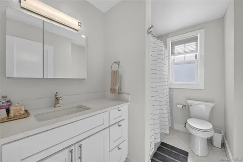 a bathroom with a sink toilet and vanity