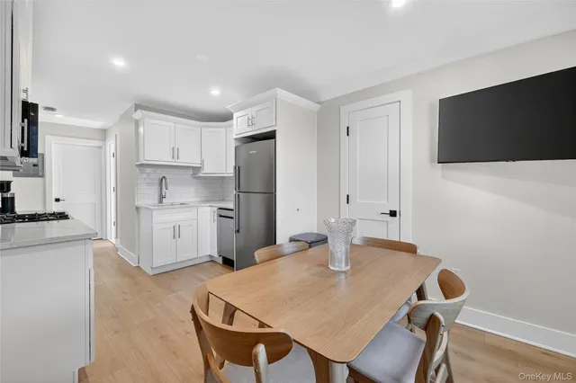 a kitchen with refrigerator cabinets and wooden floor