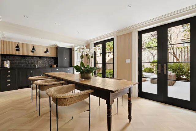 an aerial view of a residential apartment building with a yard and garage