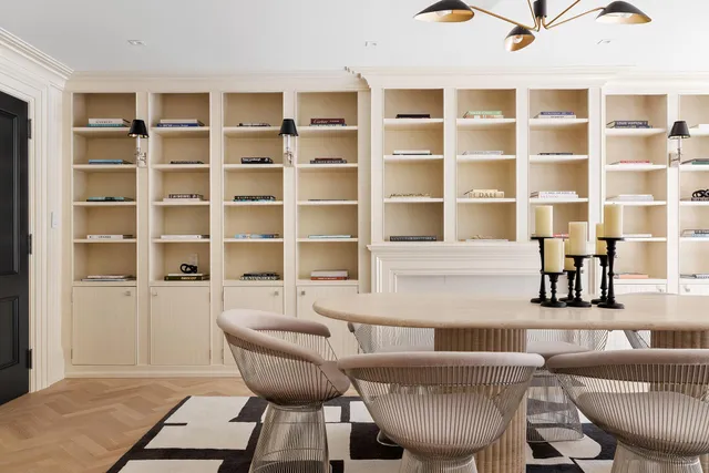 a bedroom with a bed a fireplace and a large mirror