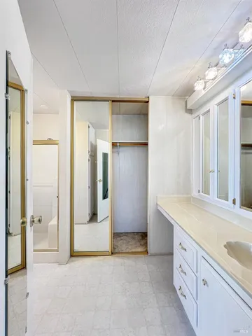 a bathroom with a granite countertop sink mirror and a