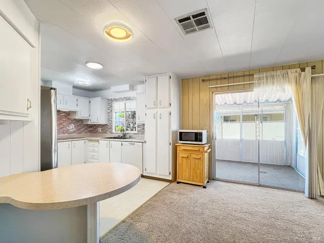 a kitchen with counter top space cabinets and stainless steel appliances