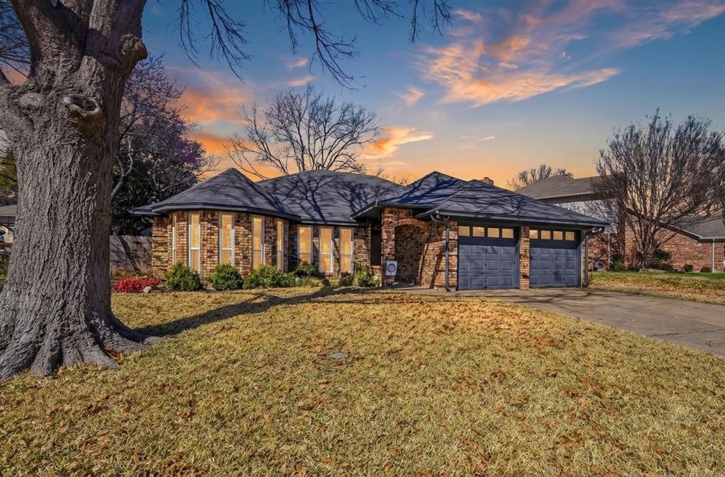 a view of a house with a yard and garage