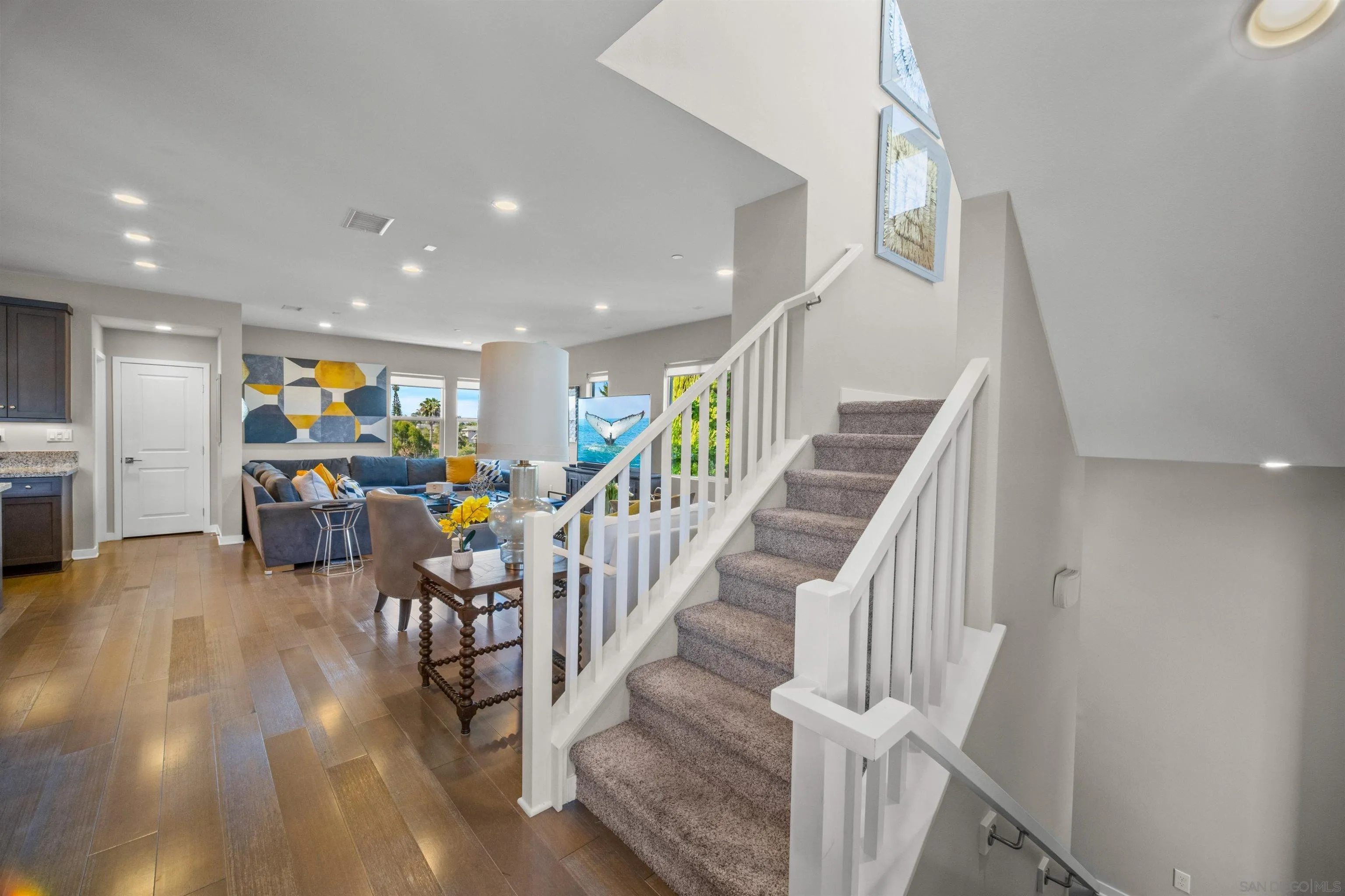 8329 Ridge Court San Diego, CA 92108 - Photo 13 of 39 a view of a hallway with wooden floor and stairs