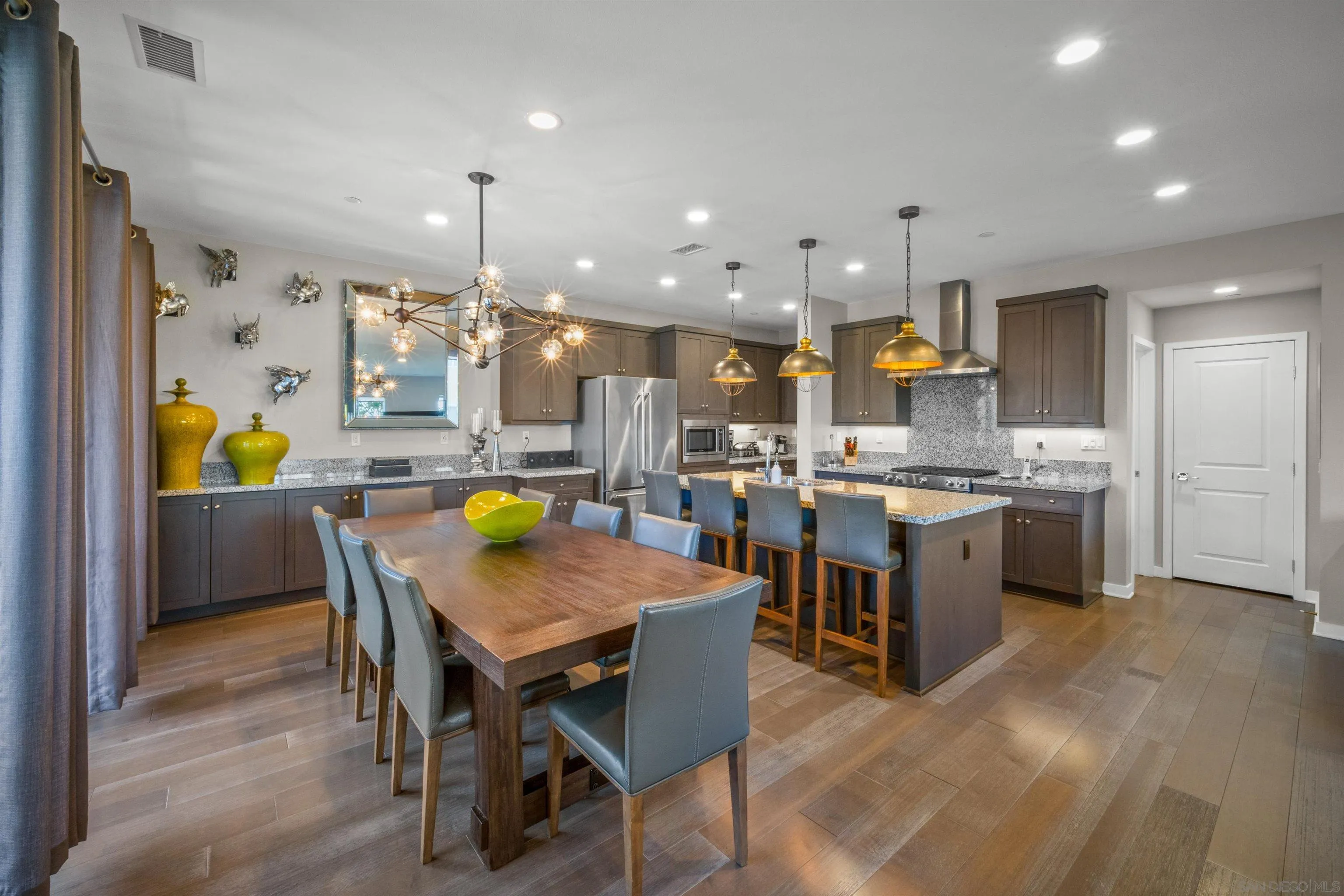 8329 Ridge Court San Diego, CA 92108 - Photo 14 of 39 a kitchen with a table chairs and a refrigerator
