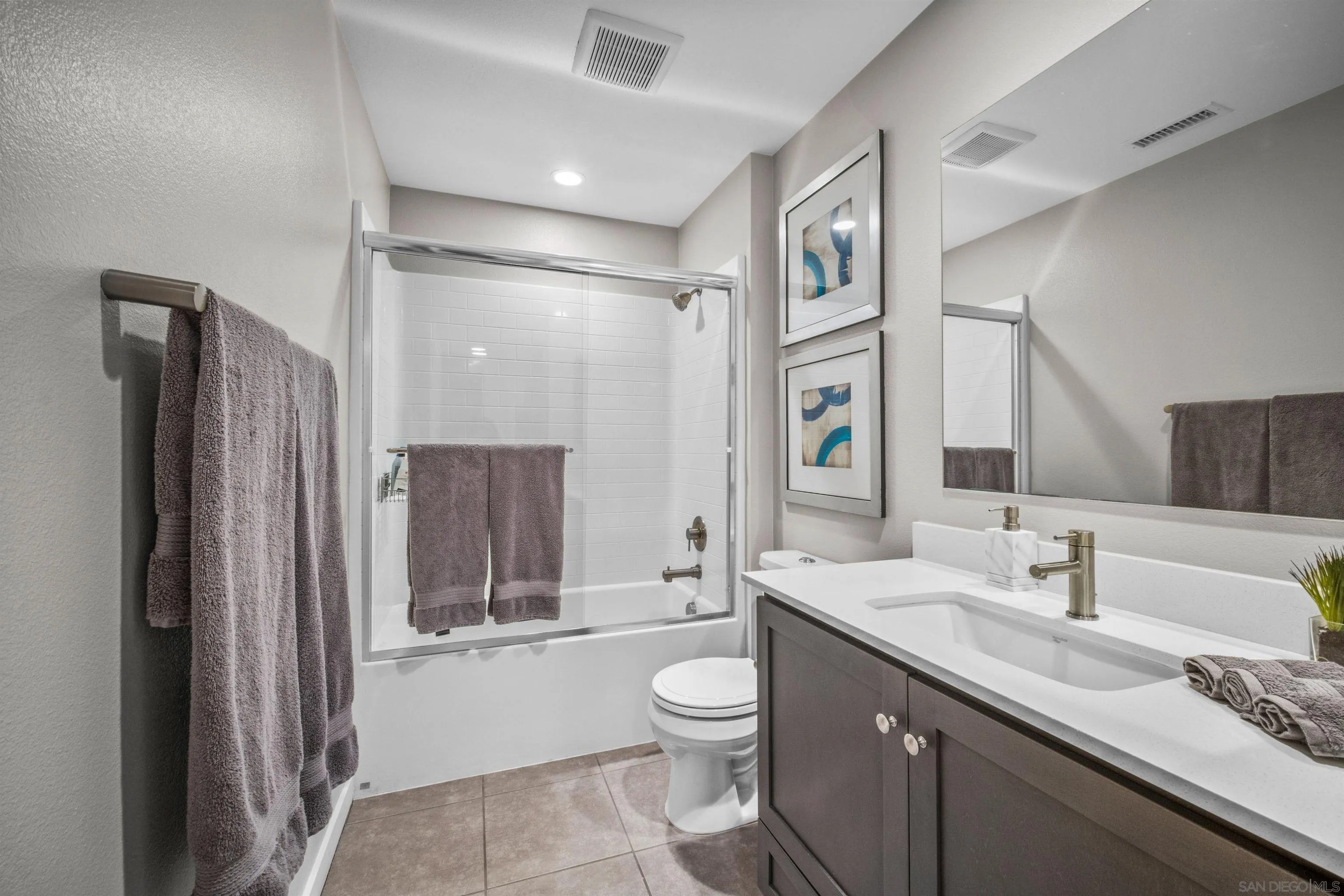 8329 Ridge Court San Diego, CA 92108 - Photo 32 of 39 a bathroom with a granite countertop sink toilet a large mirror a vanity and shower