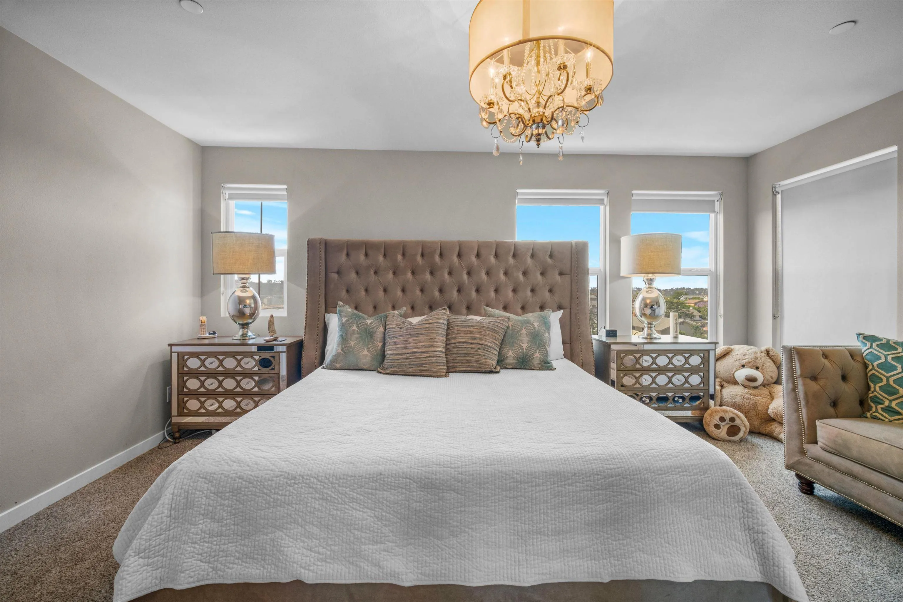 8329 Ridge Court San Diego, CA 92108 - Photo 36 of 39 a bedroom with a large bed and a chandelier