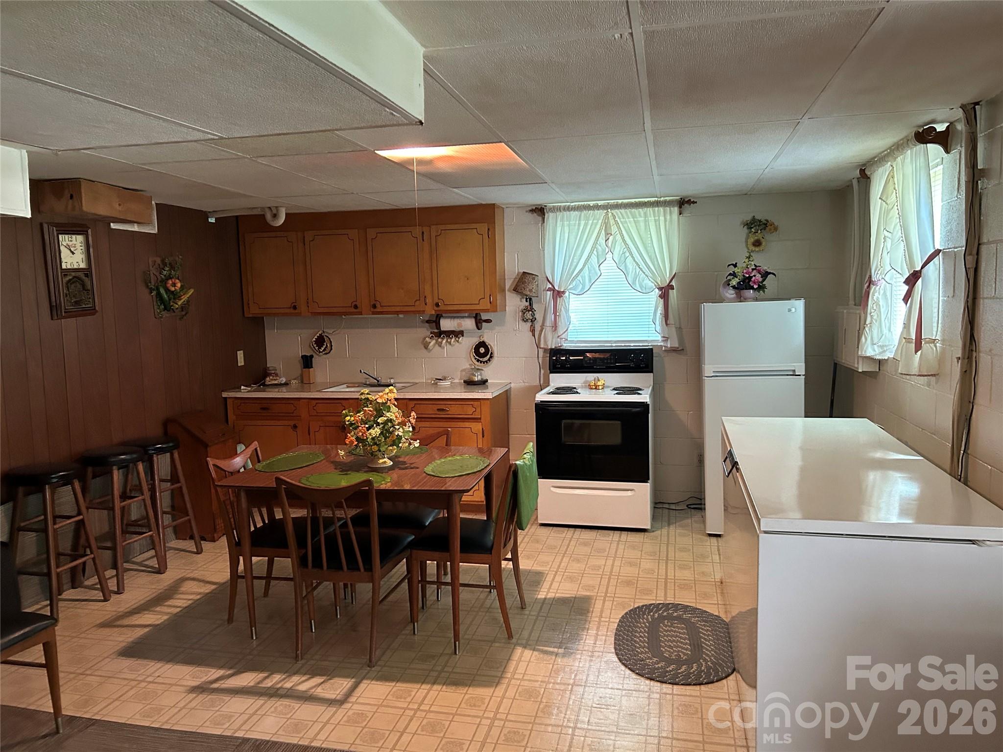 336 Bridges Road Blacksburg, SC 29702 - Photo 22 of 26 a kitchen with a dining table chairs and a refrigerator