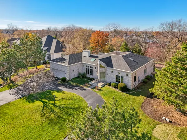 an aerial view of residential houses with a yard and ocean view