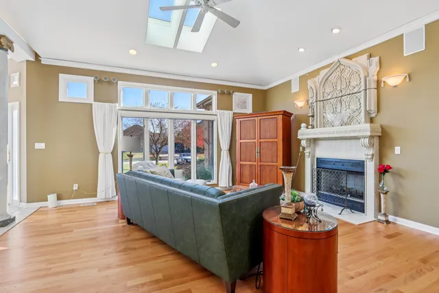 a spacious bedroom with a large bed and a chandelier