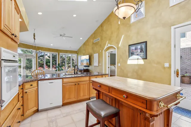 a spacious bedroom with a bed and a table in it