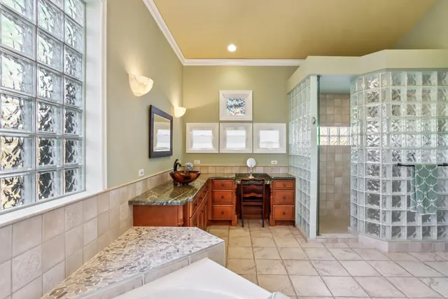 a bed room with a balcony a bed and a large window