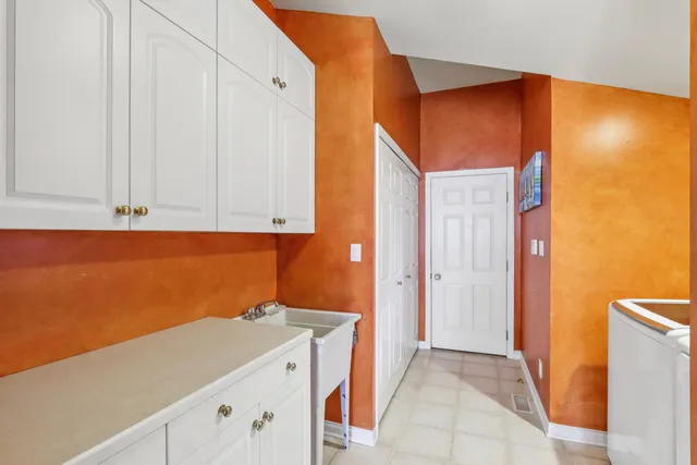 a view of a patio with table and chairs and potted plants