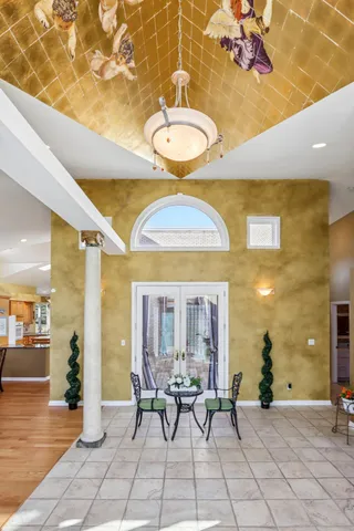 a living room with furniture kitchen view and a wooden floor