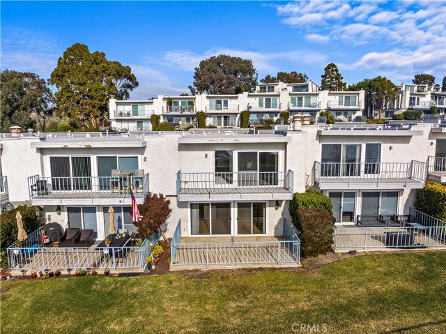 a view of a house with a swimming pool and sitting area