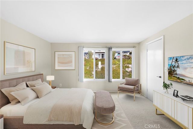 a bedroom with furniture and a flat screen tv