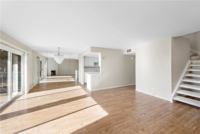 a view of a kitchen with stairs and a fireplace