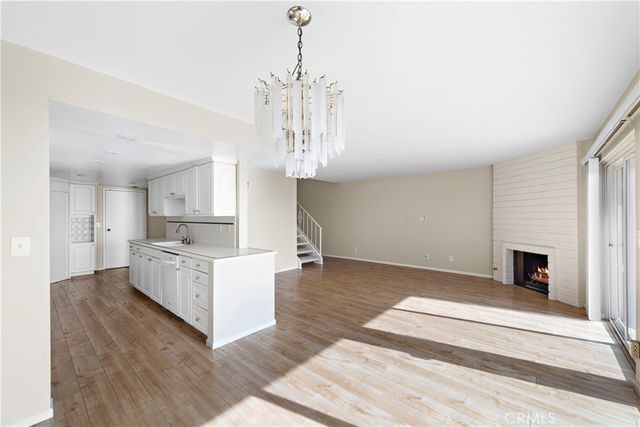a living room with kitchen island furniture and a chandelier