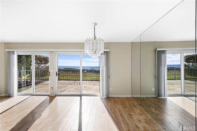 a view of a room with wooden floor and windows