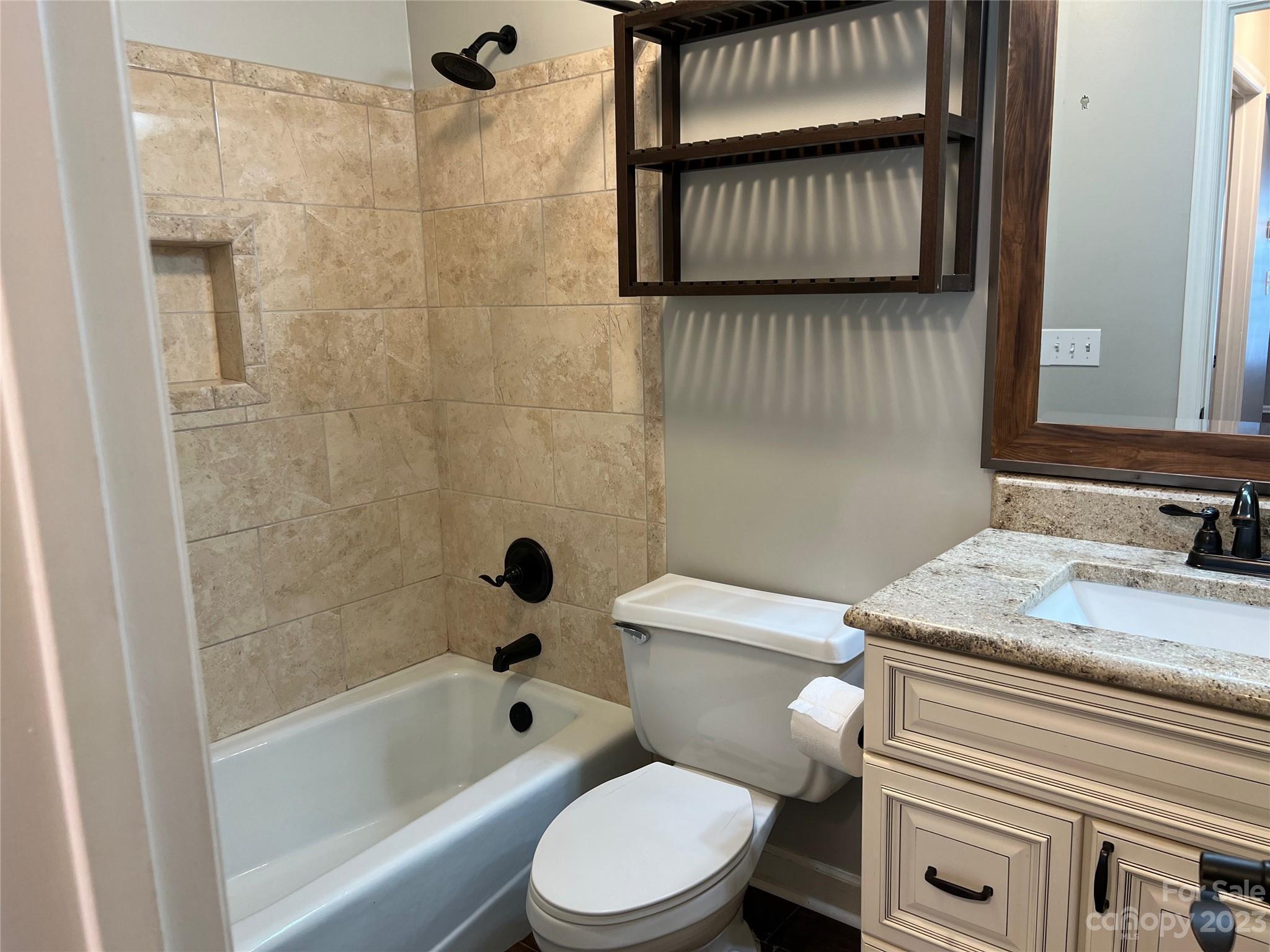 226 Queens Road Charlotte, NC 28204 - Photo 17 of 24 a bathroom with a granite countertop sink toilet and shower