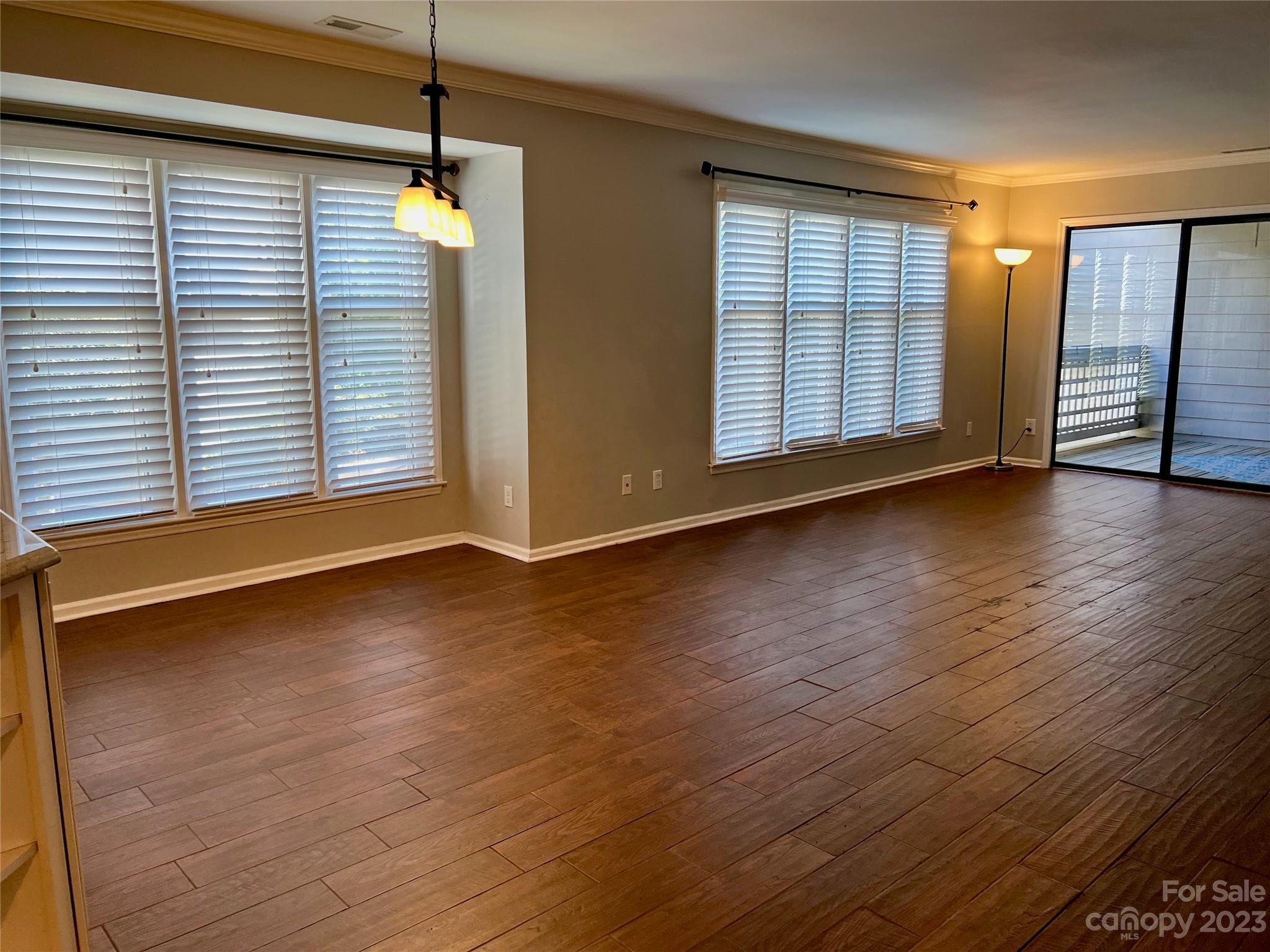 226 Queens Road Charlotte, NC 28204 - Photo 20 of 24 an empty room with wooden floor staircase and windows