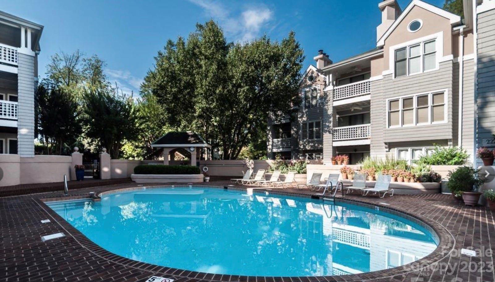 226 Queens Road Charlotte, NC 28204 - Photo 2 of 24 a swimming pool with outdoor seating and yard
