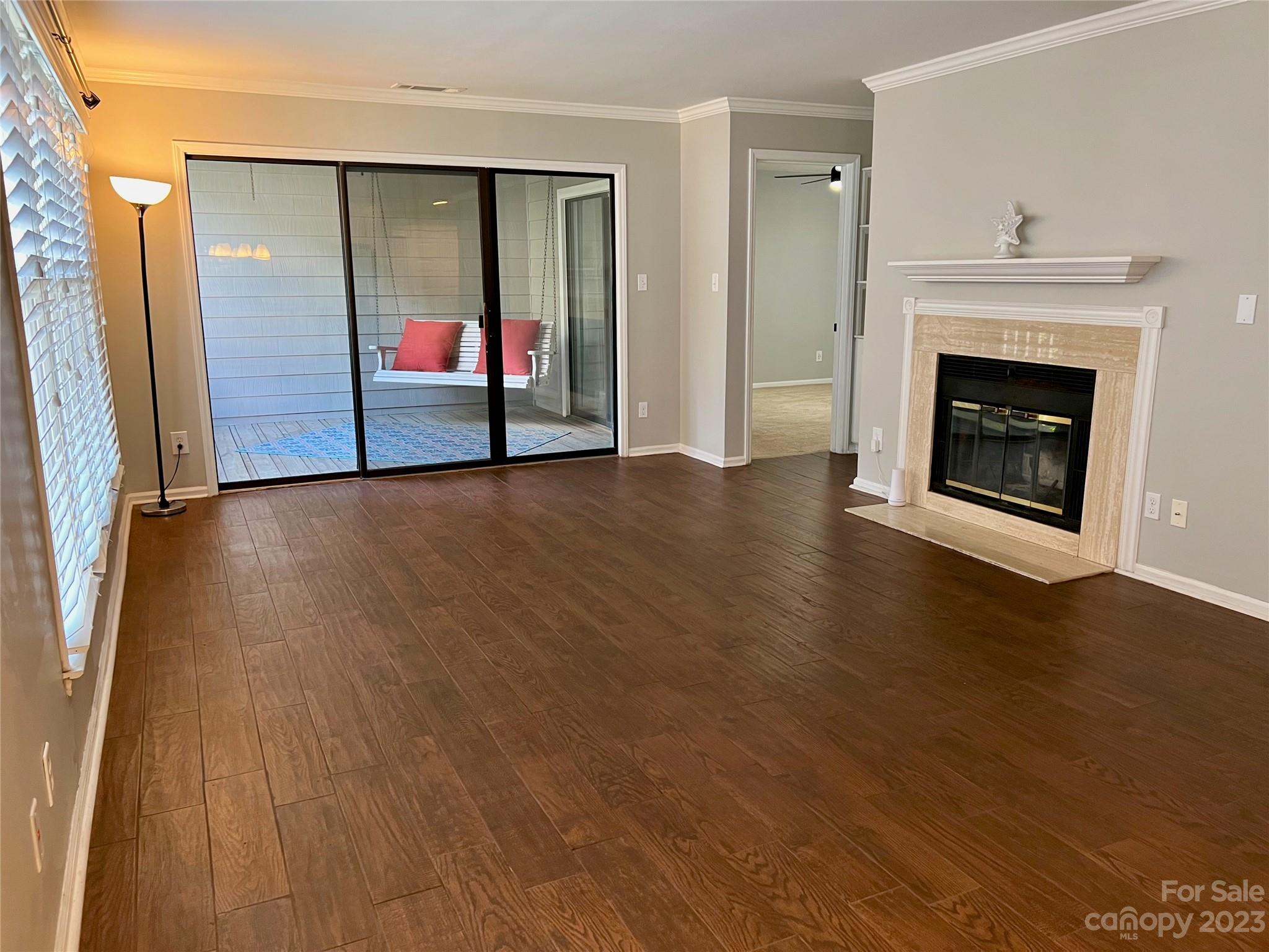 226 Queens Road Charlotte, NC 28204 - Photo 21 of 24 an empty room with wooden floor fireplace and windows