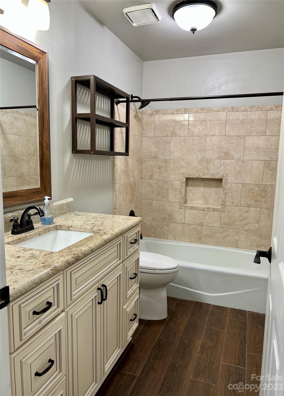 226 Queens Road Charlotte, NC 28204 - Photo 9 of 24 a bathroom with a granite countertop toilet sink and mirror