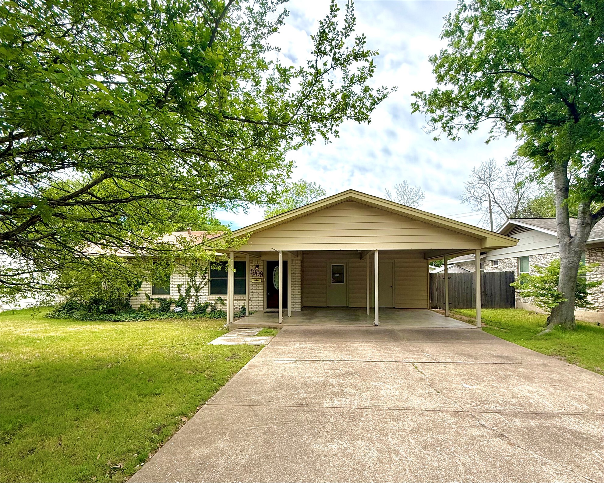 a front view of a house with yard and green space